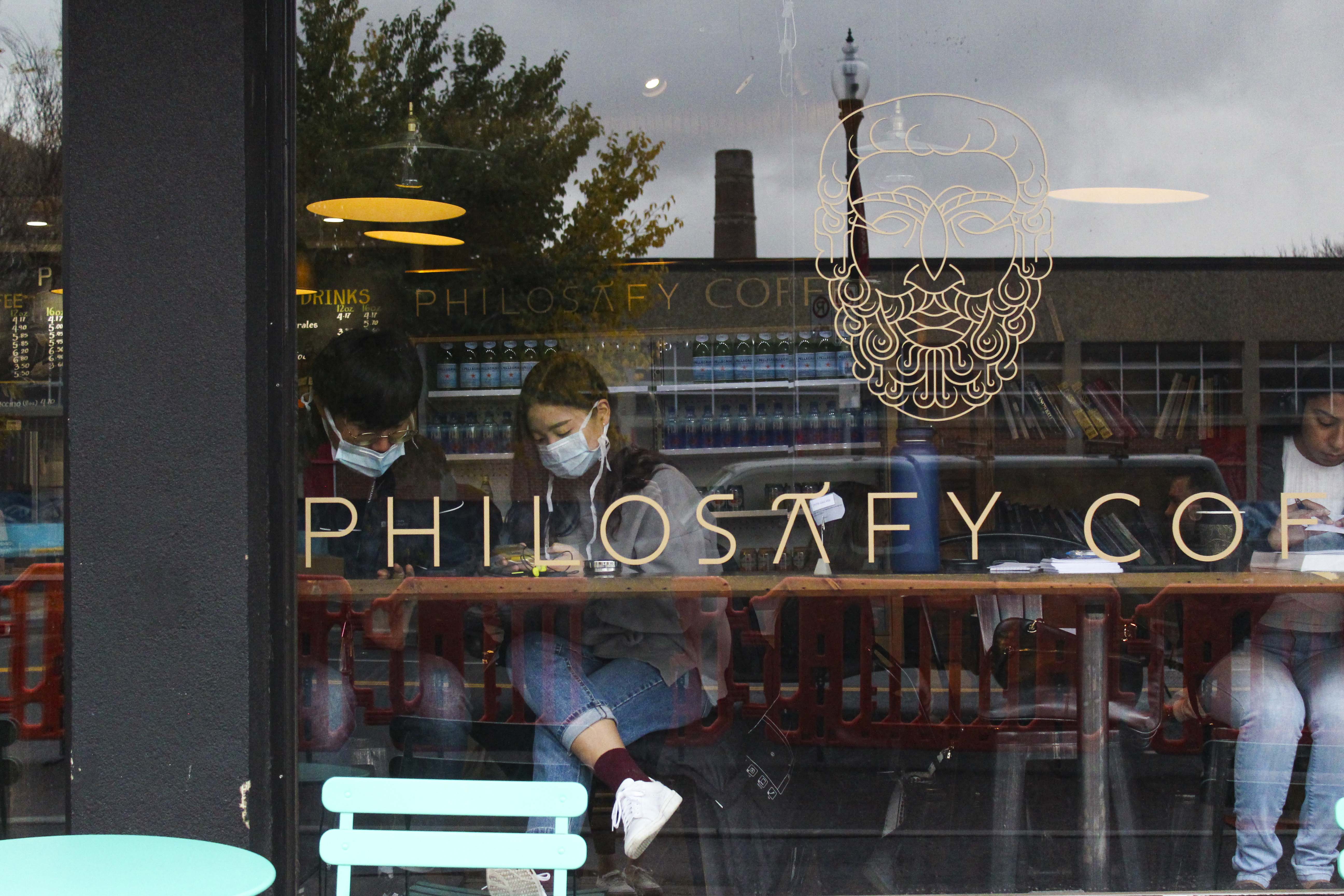 A couple wears masks in a cafe in downtown Calgary on Monday, Oct. 12, 2020. Masks are recommended by health officials when people are unable to social distance. (Photo by Meng Wei/SAIT)